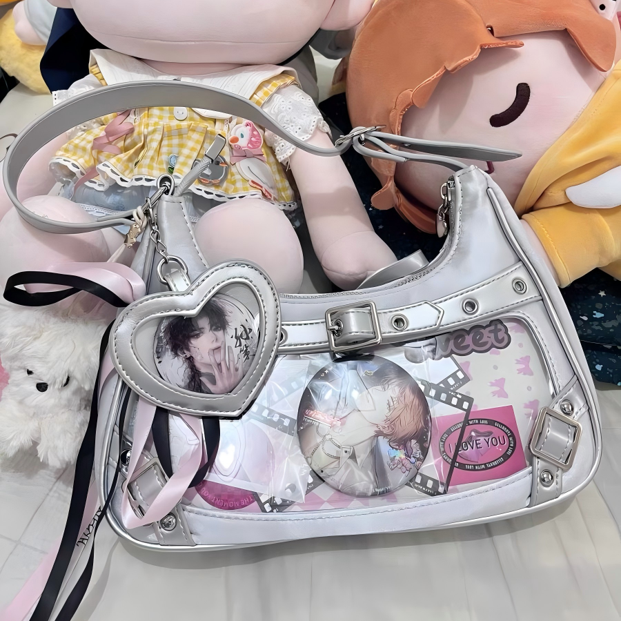 Silver buckle-detail ita shoulder bag with clear display window, shown with character collectibles for styling