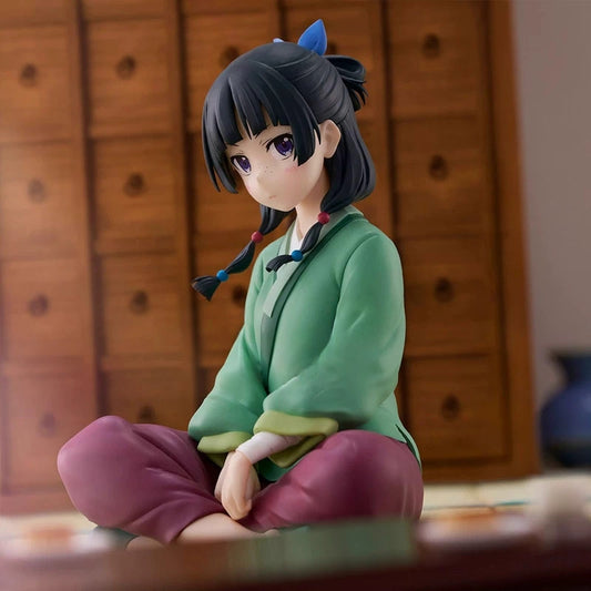 Maomao Relax Time figure sitting cross-legged in a green top and burgundy skirt