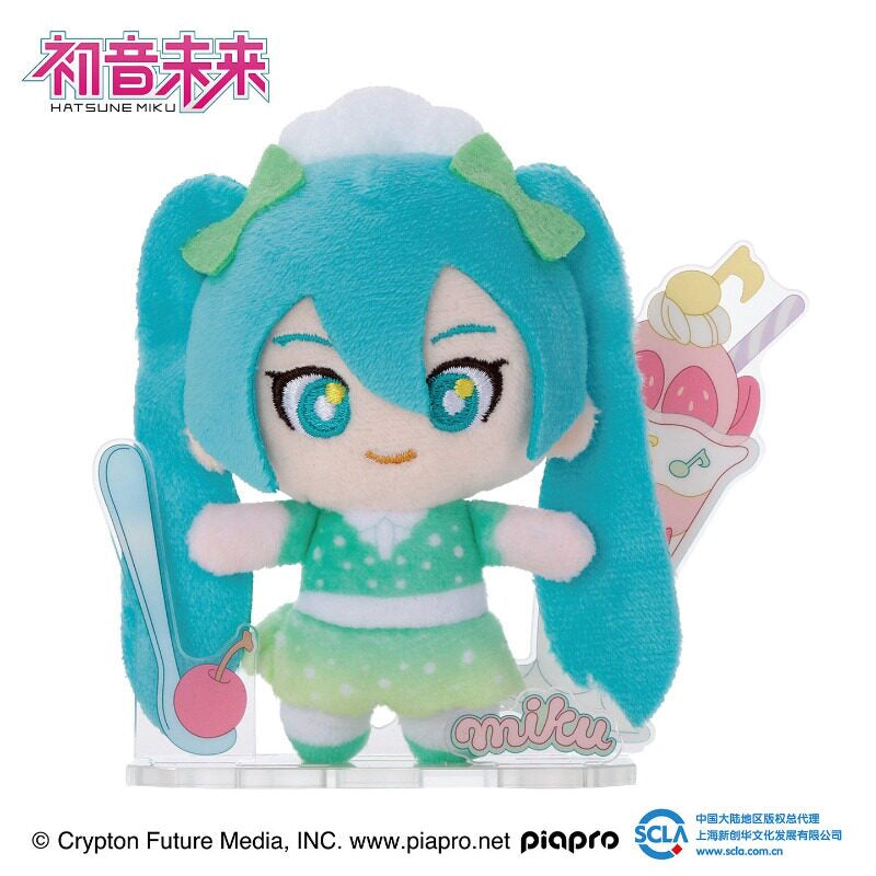 Hatsune Miku plush in green with dessert-themed acrylic display
