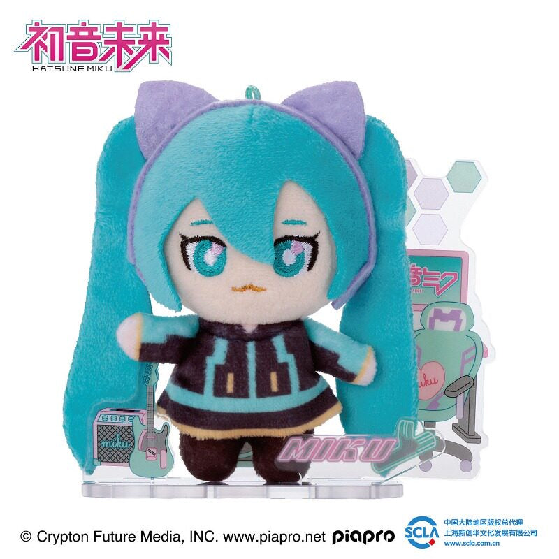 Hatsune Miku plush with cat-ear headset and gaming-themed acrylic display